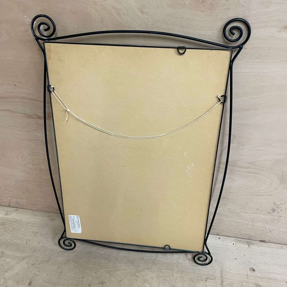 Black metal scroll framed mirror