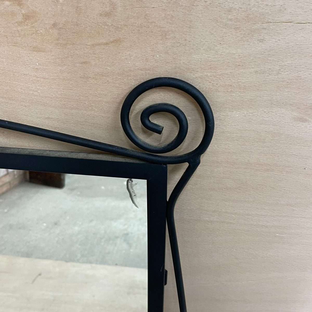 Black metal scroll framed mirror