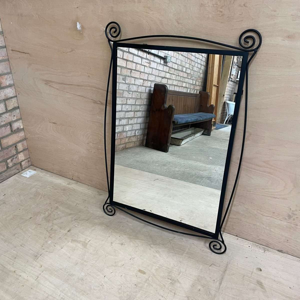 Black metal scroll framed mirror