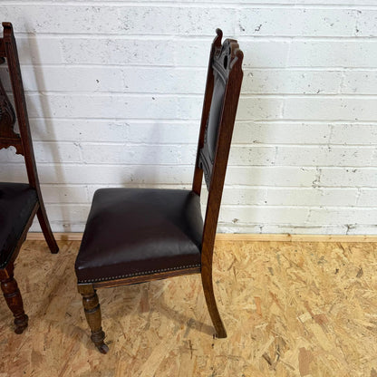 Pair Edwardian? Jacobean Style Dining Chairs Leather Seats Carved Backs Castors