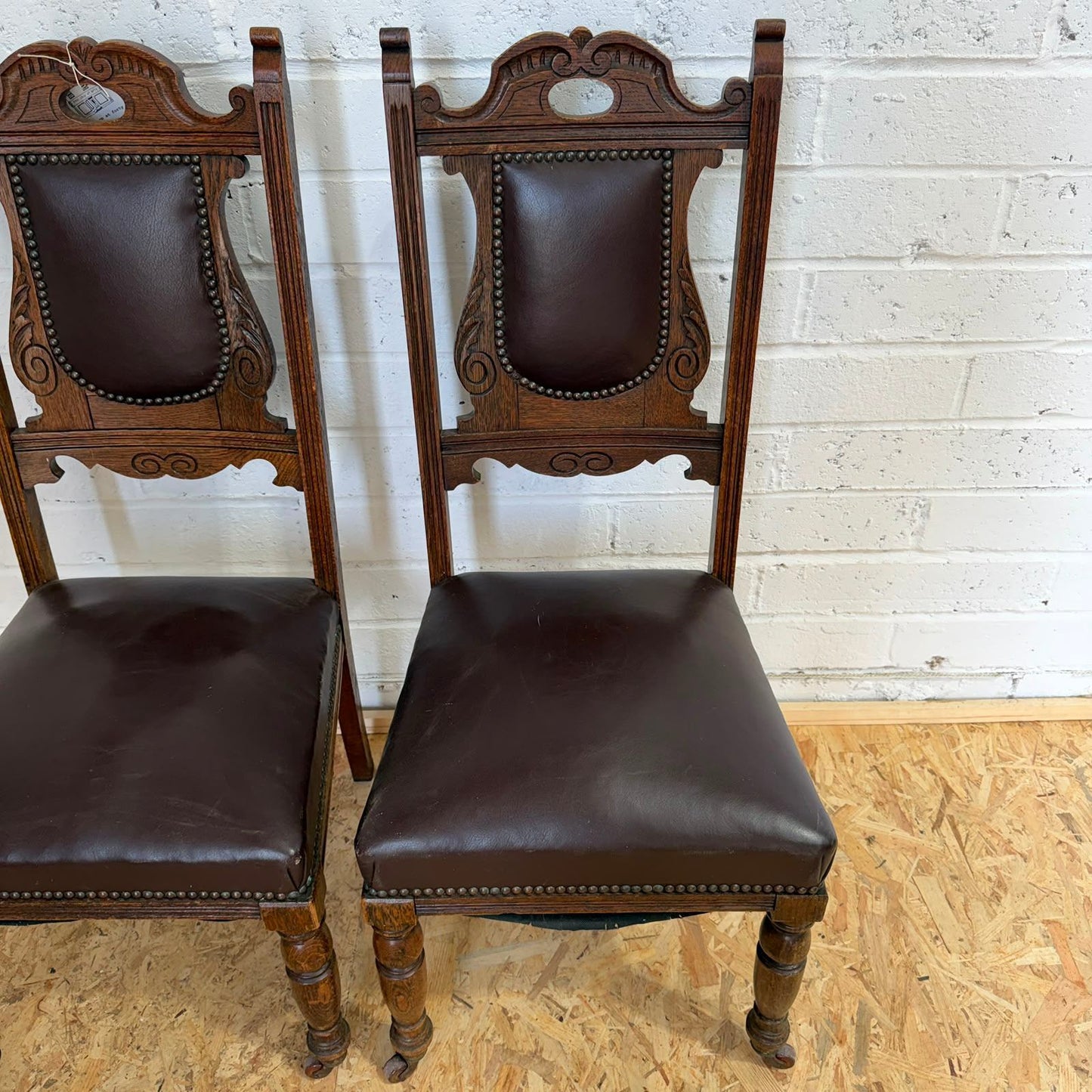 Pair Edwardian? Jacobean Style Dining Chairs Leather Seats Carved Backs Castors
