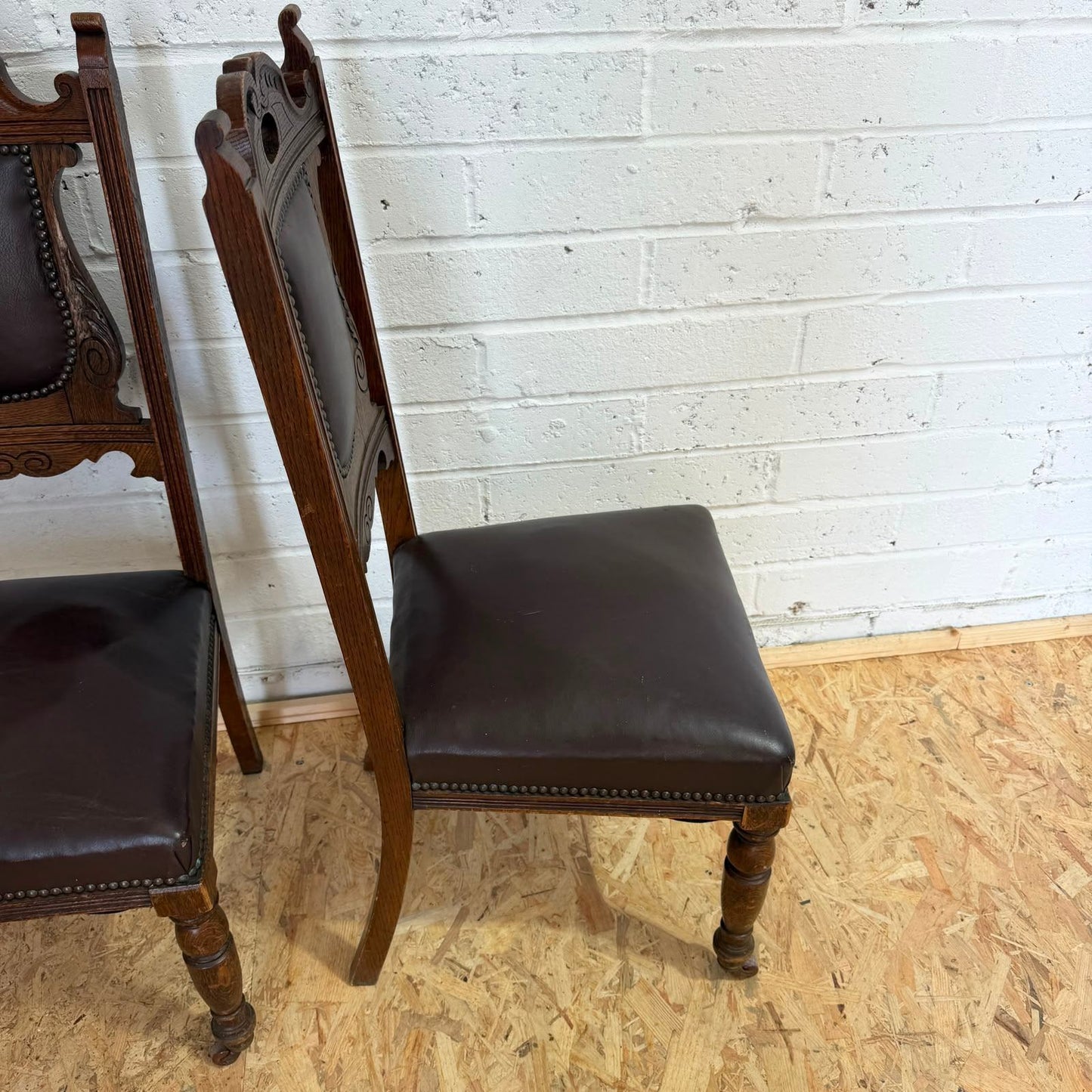 Pair Edwardian? Jacobean Style Dining Chairs Leather Seats Carved Backs Castors