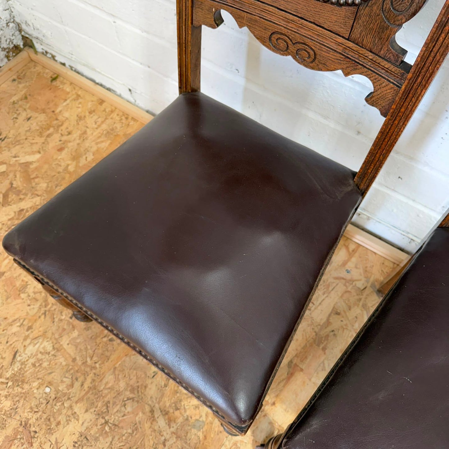 Pair Edwardian? Jacobean Style Dining Chairs Leather Seats Carved Backs Castors