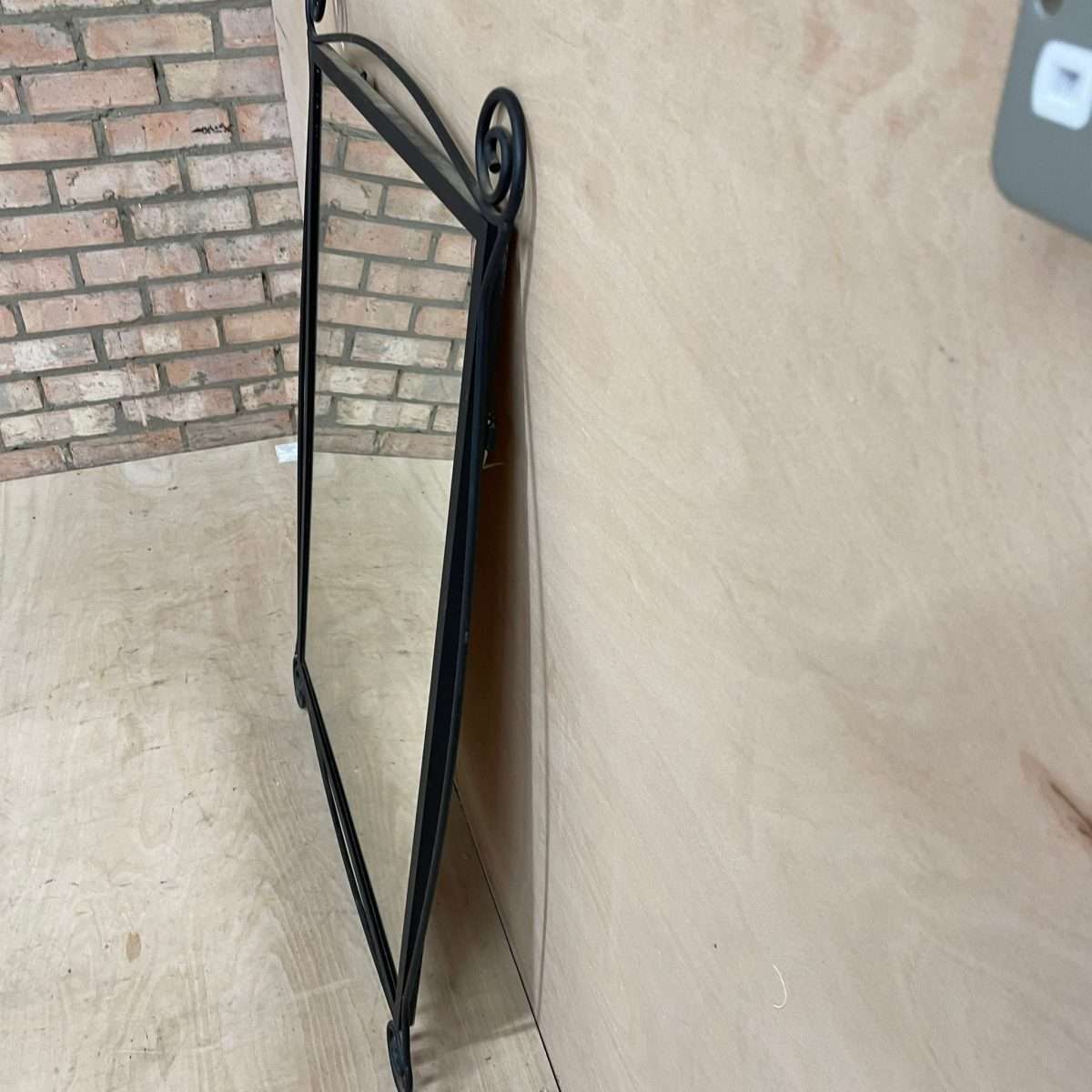 Black metal scroll framed mirror