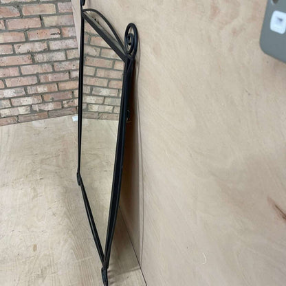 Black metal scroll framed mirror